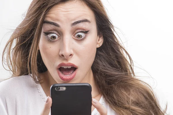 Shocked woman looking at phone — Stock Photo, Image