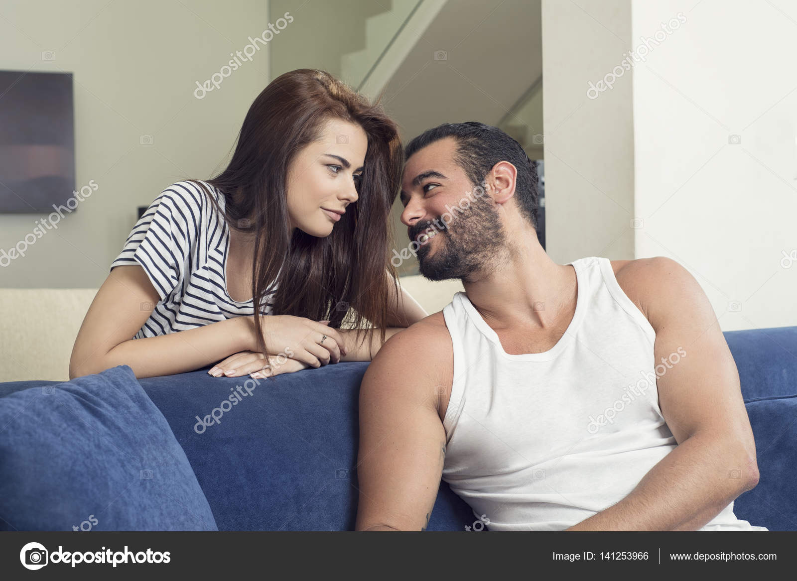 Couple cuddling on sofa Stock Photo by ©diplomedia 141253966