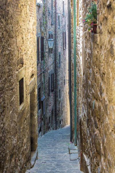 Typical alley in the medieval town of Cortona, in tuscany, Italy