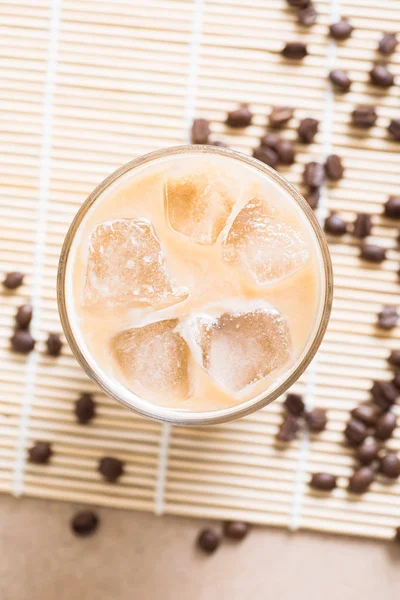 Glass of ice coffee with coffee bean on wooden background — Stock Photo, Image