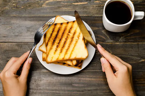 Toast and coffee on wooden background — Stock Photo, Image