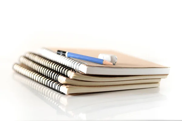 Pilha de notebook com lápis e borracha — Fotografia de Stock