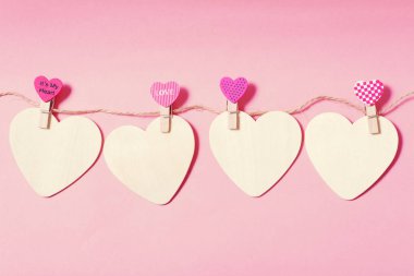 Giysi mandal pembe bir arka plan üzerinde beyaz Kalpler