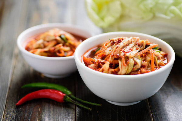 kimchi cabbage in a bowl on wooden background, Korean food