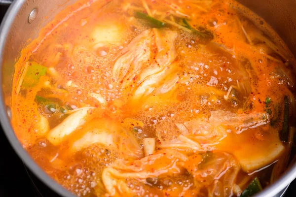 Kimchi soup cooking in hot pot, Korean food