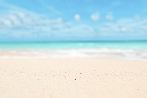 Sand, sky, sea summer concept with defocused backgroound