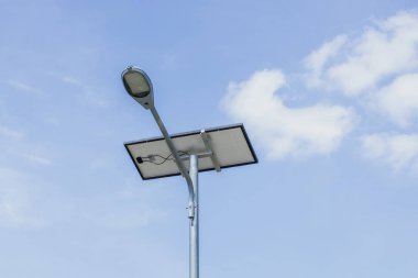 Mavi gökyüzü arka plan bulutlar ile Güneş enerjili sokak ışık.