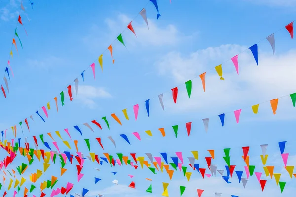 multi colored party rainbow flags on blue sky for celebration