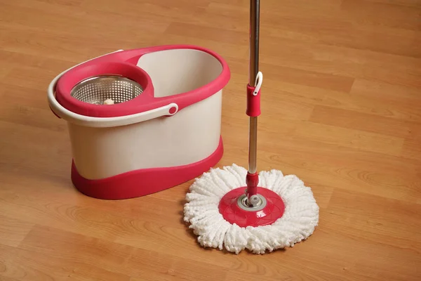 Cleaning mop and Bucket With Drying Spinner on Wooden Floor — Stock Photo, Image