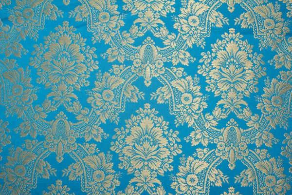 Güzel, parlak desenli ağır kumaş.