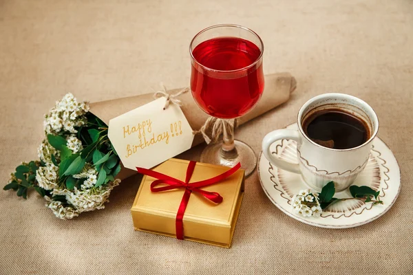 Romantic Birthday Breakfast.Cup of Coffee.Glass of Red Drink.Wish Card with Flowers.Present in Golden Box with Red Ribbon