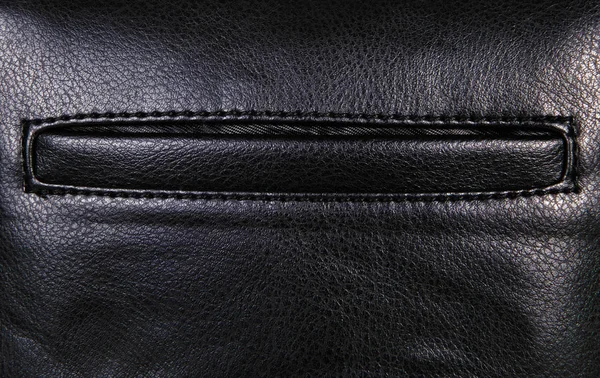 Černá kožená pozadí s marží a kapsy, hrubý vzorek — Stock fotografie