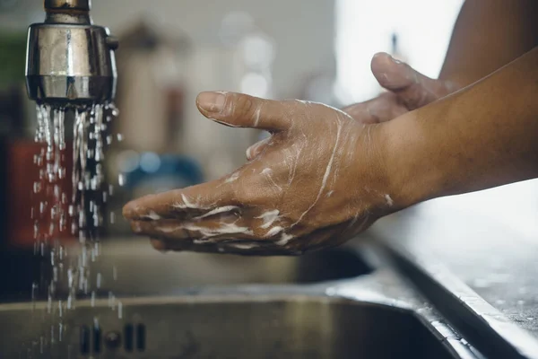 Always start with clean hands to prevent spreading of the coronavirus (Covid-19). Cropped shot of an asian man washing his hands at home