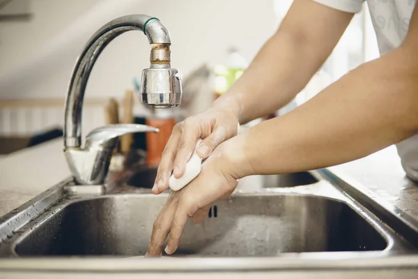 Always start with clean hands to prevent spreading of the coronavirus (Covid-19). Cropped shot of an asian man washing his hands at home