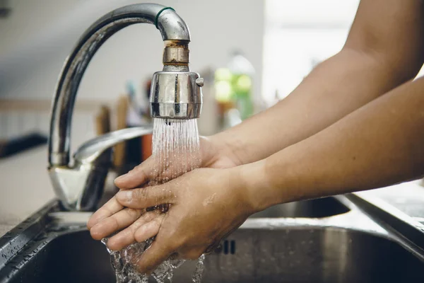 Always start with clean hands to prevent spreading of the coronavirus (Covid-19). Cropped shot of an asian man washing his hands at home