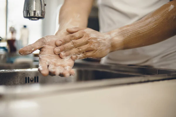 Always start with clean hands to prevent spreading of the coronavirus (Covid-19). Cropped shot of an asian man washing his hands at home