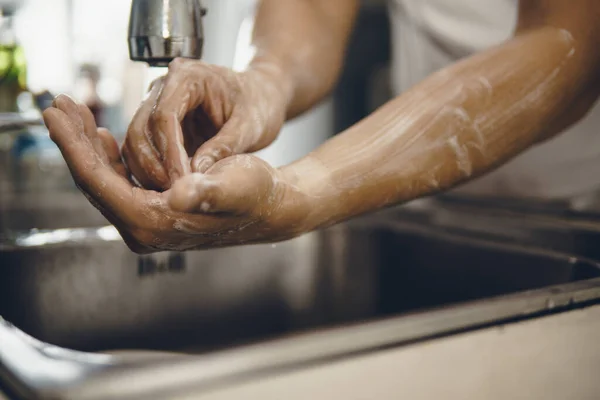 Always start with clean hands to prevent spreading of the coronavirus (Covid-19). Cropped shot of an asian man washing his hands at home