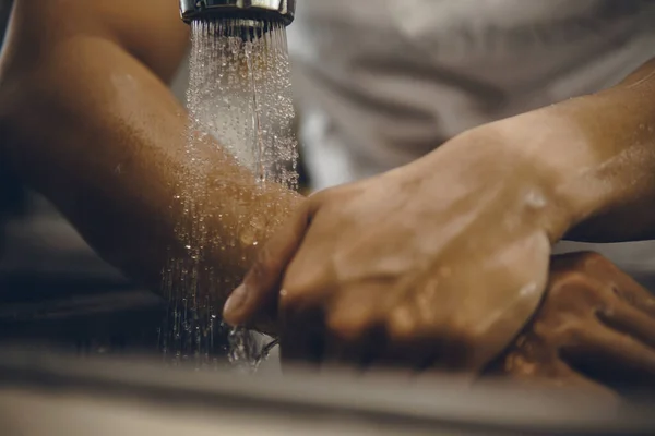 Always start with clean hands to prevent spreading of the coronavirus (Covid-19). Cropped shot of an asian man washing his hands at home