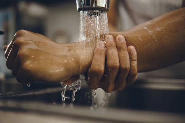 Always start with clean hands to prevent spreading of the coronavirus (Covid-19). Cropped shot of an asian man washing his hands at home