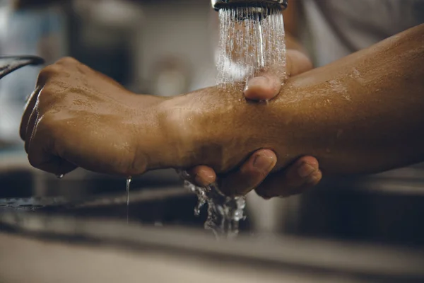 Always start with clean hands to prevent spreading of the coronavirus (Covid-19). Cropped shot of an asian man washing his hands at home