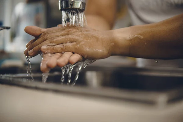 Always start with clean hands to prevent spreading of the coronavirus (Covid-19). Cropped shot of an asian man washing his hands at home