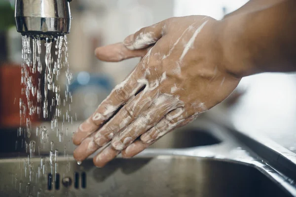 Always start with clean hands to prevent spreading of the coronavirus (Covid-19). Cropped shot of an asian man washing his hands at home