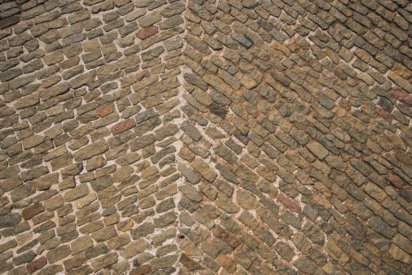 cobbled road as background. stone brick old row floor road