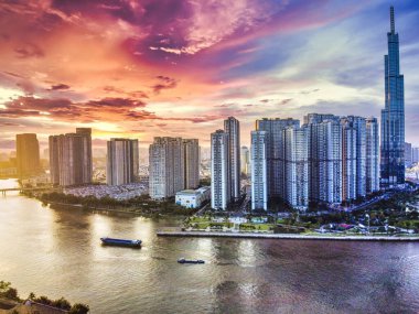 Aerial view of Ho Chi Minh City skyline and skyscrapers in center of heart business at Ho Chi Minh City downtown. Panorama of cityscape on Saigon river in Ho Chi Minh City at Vietnam at sunset scene