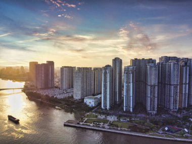 Aerial view of Ho Chi Minh City skyline and skyscrapers in center of heart business at Ho Chi Minh City downtown. Panorama of cityscape on Saigon river in Ho Chi Minh City at Vietnam at sunset scene