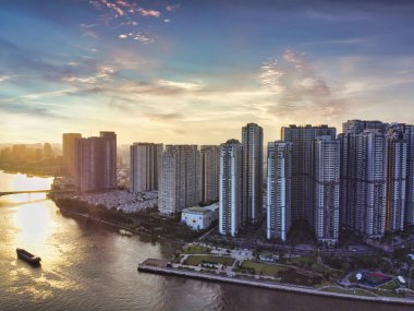 Aerial view of Ho Chi Minh City skyline and skyscrapers in center of heart business at Ho Chi Minh City downtown. Panorama of cityscape on Saigon river in Ho Chi Minh City at Vietnam at sunset scene