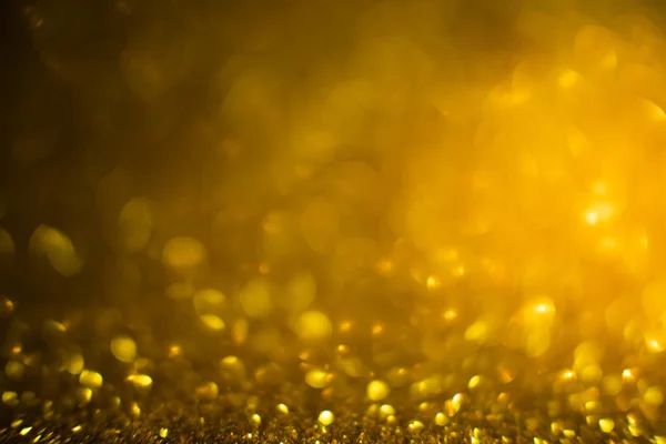 Abstract of Bright and sparkling bokeh background. golden and diamond dust bokeh - blurred lighting from glitter texture. Blue color Luxury design background. Gold festive glitter background with bokeh golden lights.