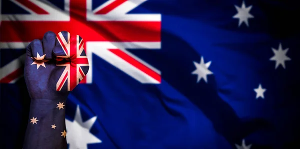 Banner of Flag of Australia painted on male fist, fist flag, country of Australia, strength, power, concept of conflict. On a blurred background with a good place for your text.