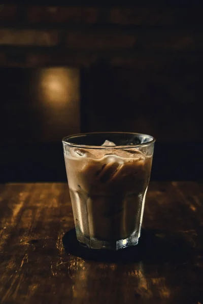 Vietnamese Milk Coffee on Wooden Table. Traditional Hot Drinks in Vietnam. Close-up Vietnamese Drip Coffee and Ice mug served with milk, Iced black coffee.