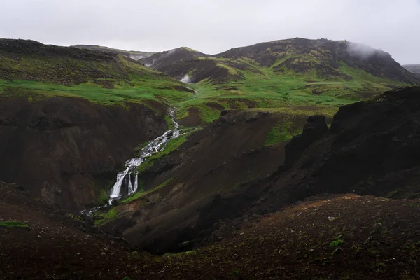 Waterfall coming from steamy valley — 스톡 사진