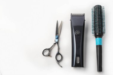 Beyaz arkaplanda makas, saç makası ve taraklar.