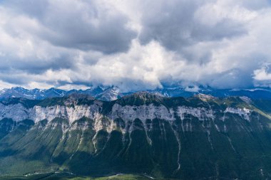 View of clouds blanketing Rocky Mountains from Mt Rundle