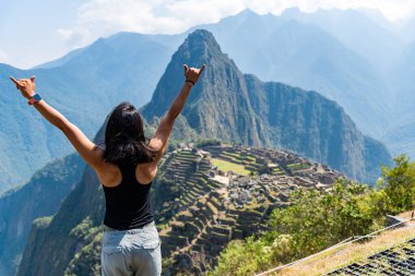 Woman enjoying the view of Machu Picchu Peru South America clipart