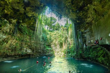 People swimming ni Ik Kil Cenote Yucatan Mexico North America clipart