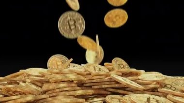 Altın bitcoins ağır çekim yığının üstüne düşmek. Altın sikke üzerinde siyah arka plan 4 k slowmotion alfa kanalı ile video düşüyor. Cryptocurrency incelemesi kavramı.