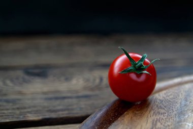 cherry tomatos on wooden cutting board