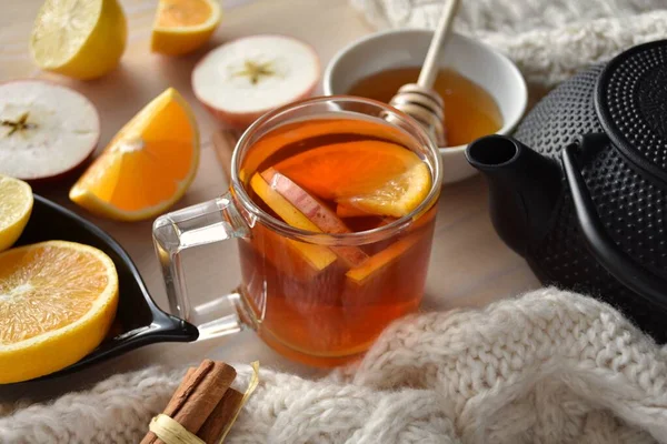 Warming aromatic Christmas tea with fresh apples, orange, lemon and cinnamon