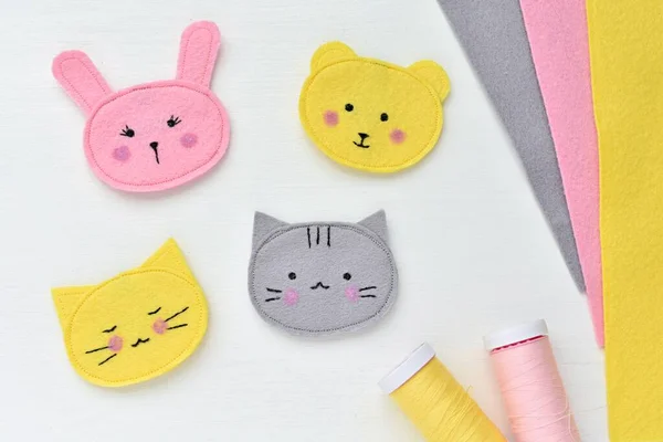 Handmade cute kawaii face animals brooches, fabrics and sewing tools, felt crafts.