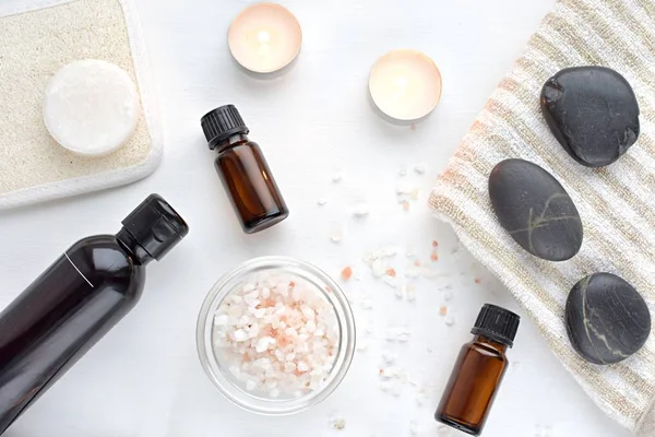 Spa composition, beauty and massage products, essential oils, massage stones, sea salt, candles.