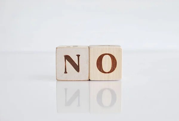 Word NO on white background with reflection. Negative answer.