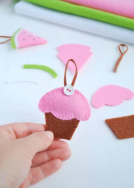 Cute toy cupcake made from felt fabric. Kids crafting.
