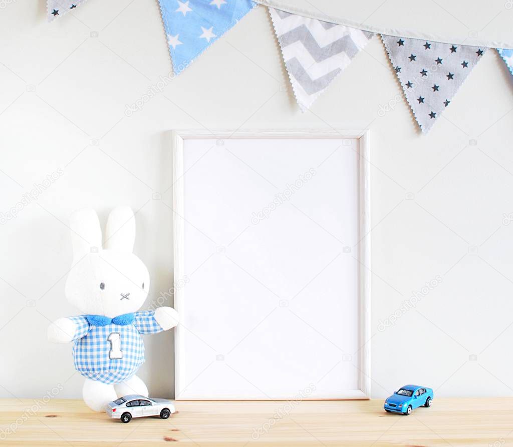 White wooden blank frame mock up for boy room decor, bunting, toy cars. Place for text, lettering, photo or art.