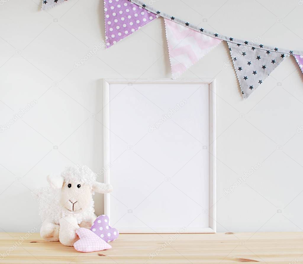 White blank frame mockup for text, photo, art, lettering on wooden table with girl room decorations. Nursery decor.