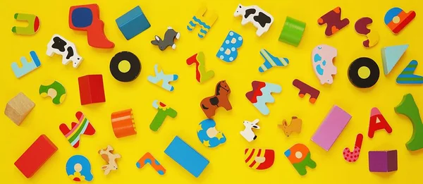 Banner Many Small Colorful Wooden Toys Yellow Background — Stock Photo, Image