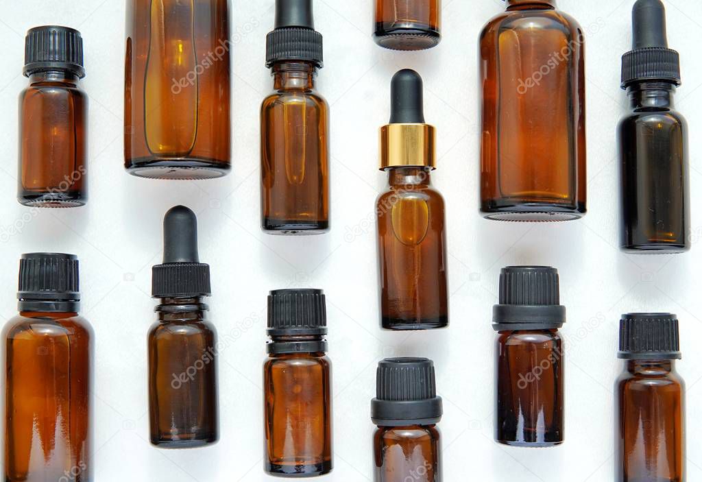 Close up view of various brown cosmetic and essential oil bottles, aromatherapy, natural cosmetics, alternative medicine, phytotherapy,  concept.