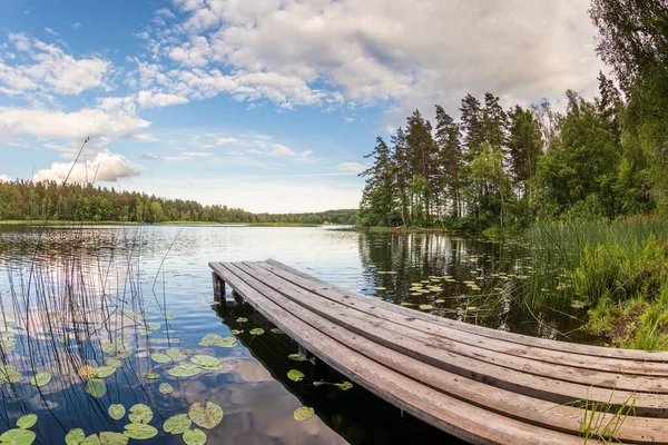 Sunset on Forest Clearing with Calm Lake and Wooden Footbridge S